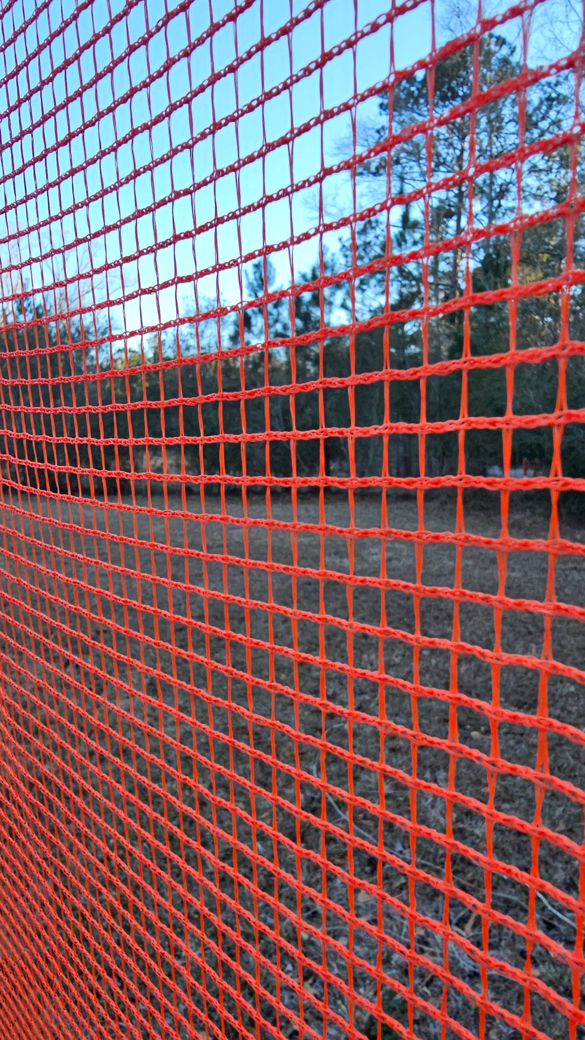 Outdoor shooting range barrier netting installed on wooden frame